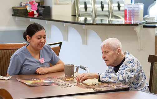 A nurse helping a patient with a puzzle. Links to Gifts by Will will.jpg