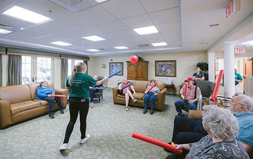 An employee doing an activity with the residents. Links to Gifts That Protect Your Assets assets.jpg